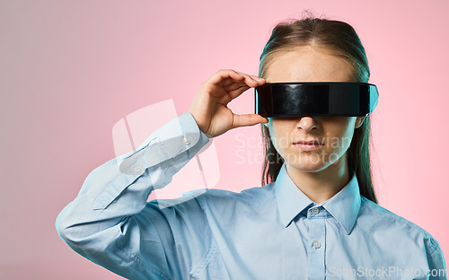 Image of Virtual reality glasses, metaverse and futuristic tech with young woman on pink background, AI and cyberpunk. Gen z, VR goggles and video game with gamer, cyber space and scifi in the digital world