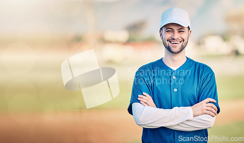 Image of Portrait, smile and mockup with a baseball man standing arms crossed outdoor on a sports pitch. Fitness, training and happy with a young male athlete posing next to blank mock up space on a field