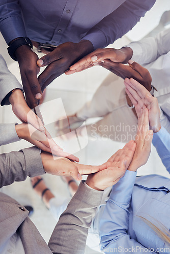 Image of Hands, collaboration and workflow with a business team standing in a circle at the office from above. Meeting, partnership and teamwork with a group of people in a huddle for growth or synergy
