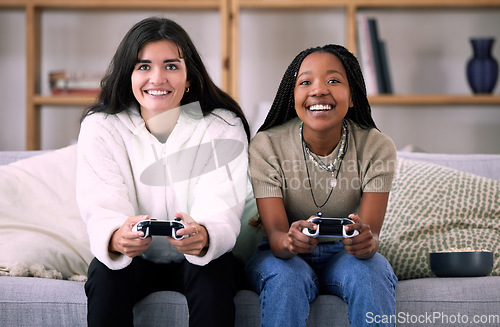 Image of Friends, women on sofa and video games for quality time, relax or happiness on break, competitive or multiplayer app. Female gamers, ladies or controllers for esports, fun or entertainment with smile