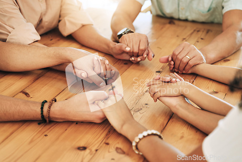 Image of Holding hands, praying and support by group of people or family together in unity, spiritual and faith in God and gratitude. Closeup, Solidarity, religion and hope in a home due to grief