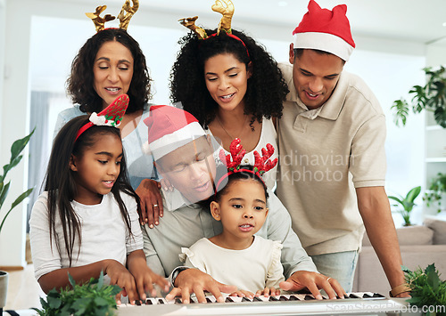 Image of Black family, christmas singing and together at piano for learning, festive celebration or bonding. Father, teaching and girl at keyboard for development, education or holiday for music, mom and kids