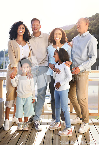 Image of Love, happy and portrait of a big family outdoor on the balcony of their modern house. Happiness, smile and girl children siblings standing with their parents and grandparents outside of the home.