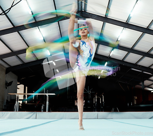 Image of Creative, ribbon and motion blur with a woman gymnast in a studio for olympics dance training or exercise. Fitness, art and gymnastics with a female dancer in a gymnasium for rhythmic practice