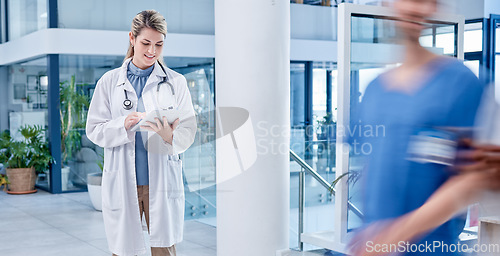 Image of Doctor, woman and tablet in hospital with motion blur, analytics and smile for results after surgery. Medic, healthcare professional and mobile touchscreen in clinic for communication on the internet
