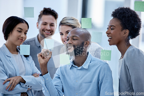 Image of Business, team and black man writing on sticky note, brainstorming and planning for project, smile and collaboration. Corporate, Nigerian male leader or staff share ideas, advertising agency or sales