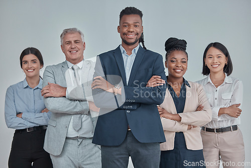 Image of Leadership, team and business people with crossed arms in a studio with confidence, unity and teamwork. Collaboration, corporate and portrait of a group of employees standing by a gray background.