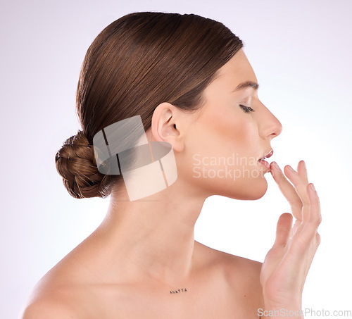 Image of Beauty, skincare and lips with a model woman in studio on a gray background for natural skin cosmetics. Luxury, wellness and transformation with an attractive young female touching her mouth