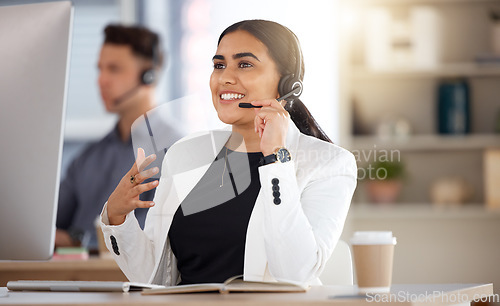 Image of Woman, call center and computer with headset consulting in telemarketing, customer service or support at office. Happy female consultant talking on mic sitting by desktop PC in contact us for sales