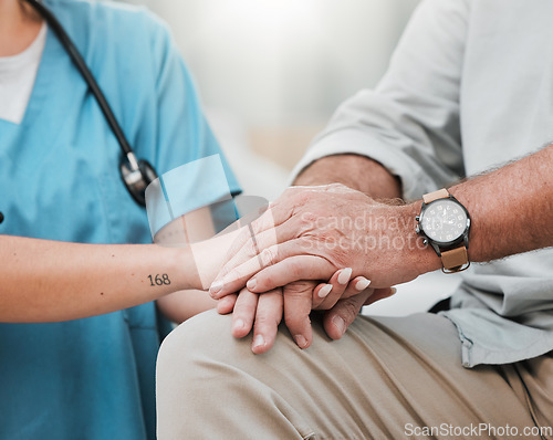 Image of Nurse holding hands with old man in hospital consulting after surgery or medical test results for support. Empathy, healthcare clinic or doctor working or helping a depressed or sick elderly person