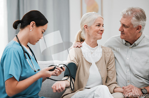 Image of Nurse, doctor or old couple with blood pressure test consulting in hospital to monitor heart wellness. Healthcare, hypertension consultation or medical physician with a happy patient for examination