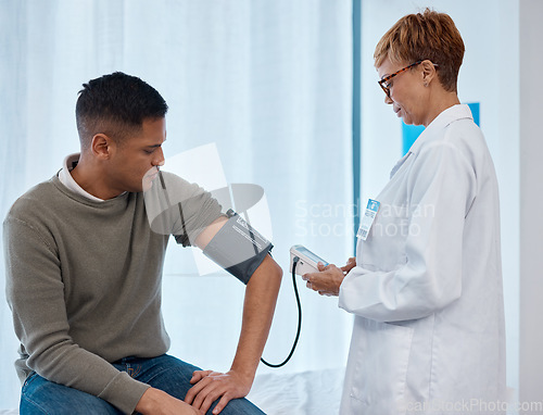 Image of Doctor, test and man with blood pressure in hospital for heart health or wellness consultation. Hypertension, healthcare or senior medical physician with patient for examination with sphygmomanometer