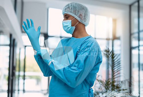 Image of Surgeon, doctor with gloves and surgery with face mask and health, man in ppe for safety, operation and ready for procedure. Cardiovascular, clean scrubs and person in clinic with male physician