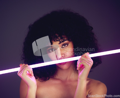 Image of Purple light, woman and beauty portrait in studio with neon uv fashion for makeup cosmetics. Face of aesthetic gen z model black person on dark background for natural art glow on skin or afro hair