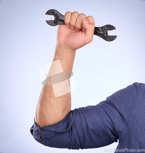 Image of Man hand holding wrench isolated on studio background for repair solution, maintenance or plumbing power. Professional worker, person or plumber with mechanic tools or gear for hard work or labor job