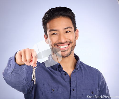 Image of House keys, happy and portrait of a man in a studio with confidence after buying property. Happiness, proud and successful male model or new homeowner from Mexico isolated by a purple background.