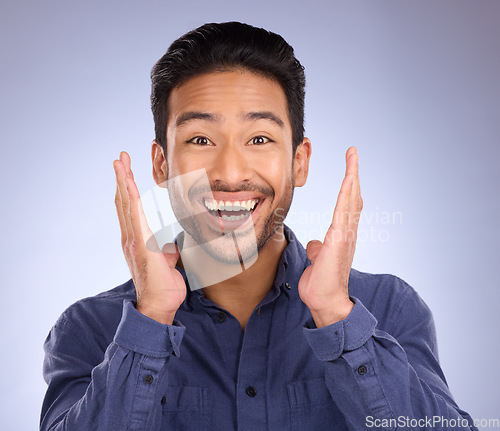 Image of Portrait, wow and Asian man with smile, surprise and excited with happy guy against blue studio background. Face, male and gentleman with happiness, shocked for good news, success and announcement