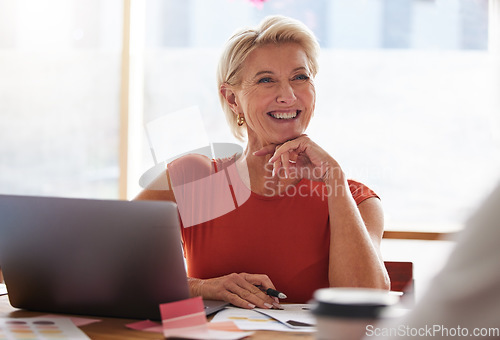 Image of Laptop, thinking and management with a senior woman in business, sitting at a table in the boardroom. Computer, thinking and smile with a happy female in leadership working alone in her office