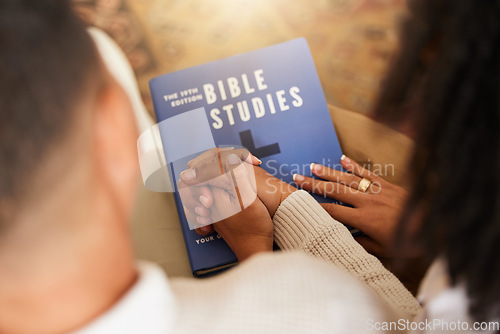 Image of Religion, studying and couple holding hands with a bible for worship, prayer and trust in relationship. Love, care and man and woman with affection while learning about God, faith and Christianity