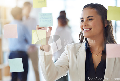 Image of Business, brainstorming and woman writing notes of agenda, research and smile at office window. Happy project manager planning ideas on glass, timeline and strategy of mission, schedule or management