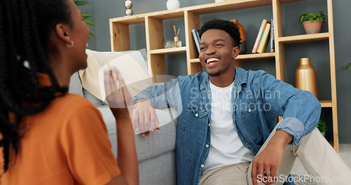 Image of Funny couple eating popcorn for game in living room, comic on date night and smile for black people love in house. Comedy, communication and crazy man and woman playing with food together in home