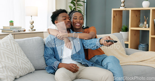 Image of Happy, love and relax couple change channels on tv remote and watching television together on sofa at home. woman hug on man while enjoying streaming entertainment show, series and movies in house