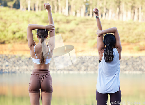 Image of Exercise, stretching and women outdoor in nature for fitness, peace and wellness. Young friends or people warm up at forest lake for workout, training and energy for mental health, chakra and zen