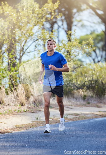 Image of Athlete, running and man exercise in a road outdoors for health, wellness and fitness for energy or cardio strength. Runner, healthy and person training or workout in the street for a challenge