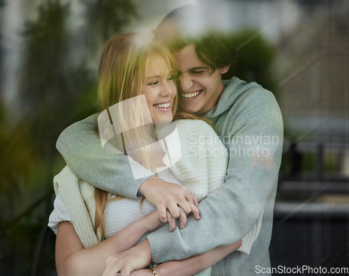 Image of Couple hug, happiness with smile by window and love with young people, partnership and holding hands with trust. Commitment, relationship and care with happy man and woman are content with joy