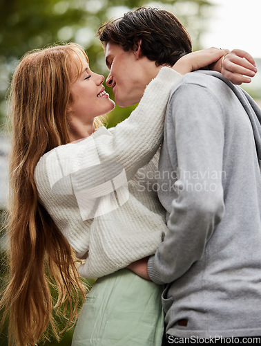Image of Couple kiss outdoor, hug with love and commitment in relationship, trust and care with gen z man and woman in park. Travel, happiness and partnership, romance and content with young people together