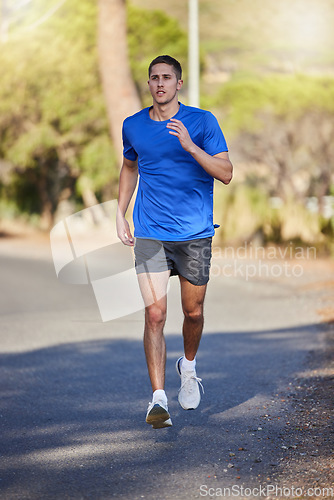 Image of Fitness, running exercise and man on road for health, wellness and strength outdoors. Sports, training and young male athlete or runner workout, cardio jog or exercising for endurance and energy.