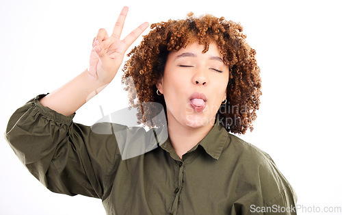 Image of Fun, happy and peace sign by woman posing tongue out and closed eyes isolated in a studio white background. Gen z, excited and cool African American female or person with casual style and happiness