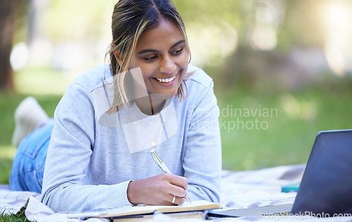 Image of Student, laptop or notebook writing in park, nature garden or school campus for learning help, studying or education research. Smile, happy or university woman on technology for college scholarship