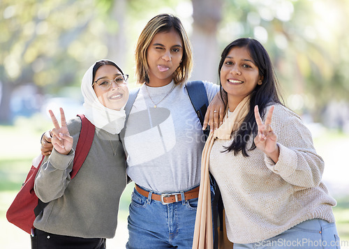 Image of Women, friends or peace sign portrait in park, nature garden or school campus in diversity bonding, comic play or goofy community. Smile, happy or Muslim students and funny face, tongue or silly face
