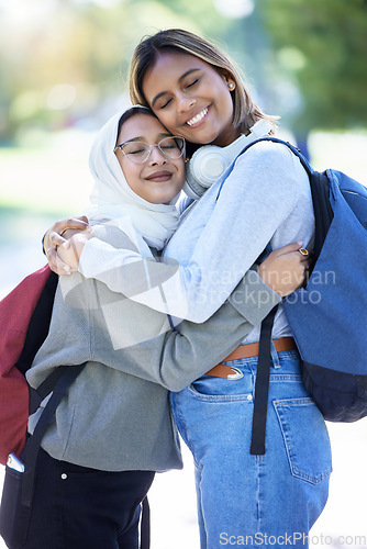 Image of Islamic students, backpack or hug in park, garden or school campus for bonding, friends acceptance or community support. Smile, happy or Muslim women in embrace, fashion hijab or university college