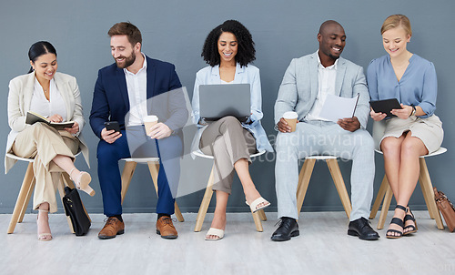 Image of Business people, diversity and networking in row for collaboration, teamwork or preparing corporate meeting. Group of diverse designers sitting in waiting room working with technology in team startup