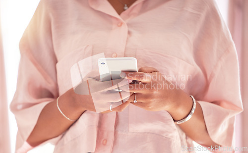 Image of Phone, hands typing and black woman in home, texting or internet browsing in house. Technology, cellphone and female holding mobile smartphone for networking, web scrolling or online social media.