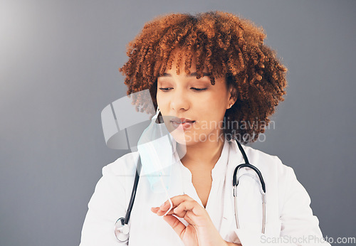 Image of Black woman, doctor and covid 19, remove face mask and health, end of pandemic and protection on studio background. Serious, mockup space with healthcare, safety and post coronavirus with female