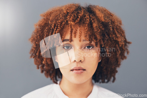 Image of Beauty, afro and black woman face or activist for empowerment and looking serious, confident and proud. Portrait, head and African American female with curly hair isolated in gray background