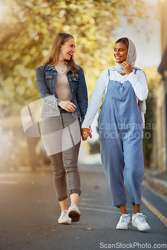 Image of Friends, happy and holding hands with women in road for support, spring and travel together. Community, diversity and smile with girls walking in street path for relax, social and solidarity