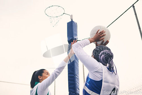 Image of Sports, netball and black woman shooting ball in match for competition, exercise or practice. Training, wellness or players playing game for workout, exercising or competitive performance outdoors.