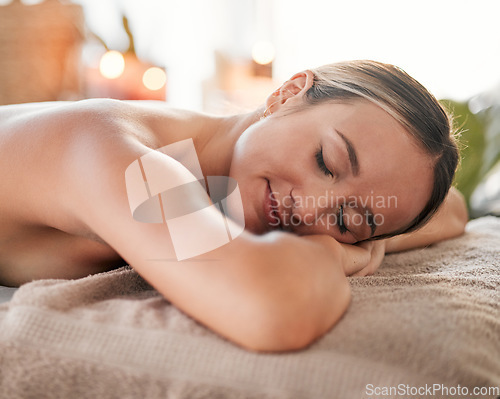 Image of Relax, spa and sleeping woman in massage bed for wellness, peace and luxury zen. Face, female and resort rest for body care, therapy and pamper treatment, happy and smile with stress free relaxation