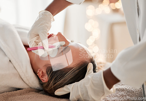 Image of Eyelash extensions, cosmetology and woman getting a beauty treatment at a salon for self care. Cosmetics, beautiful and young female getting a luxury cosmetic eye procedure from beautician at spa.