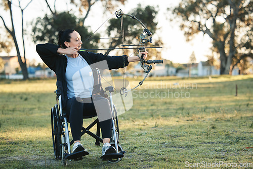 Image of Outdoor archery, disabled woman in wheelchair and challenge for active sports lifestyle in Canada. Person with disability in a park, fitness activity to exercise arms with bow and arrow for hobby