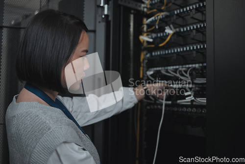 Image of Asian woman, technician and server room for cabling, networking or system maintenance at office. Female engineer plugging wire for cable service, power or data security in admin or network management