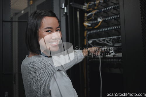 Image of Asian woman, portrait smile and technician by server for cabling, networking or system maintenance at office. Happy female engineer smiling in cable service, power or data management or admin control