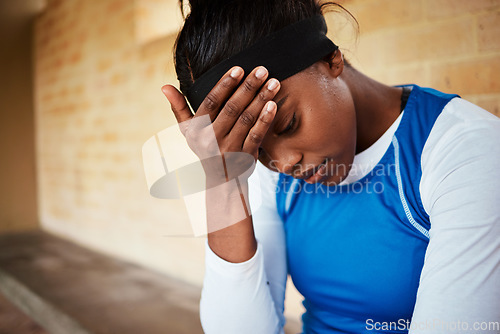 Image of stress, headache and black woman with anxiety during fitness, routine or training against a brick wall background. Athletic, audition and girl with mental health issue, nervous and worried at stadium