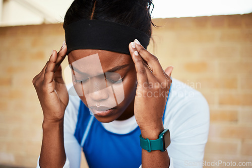 Image of Fitness, headache and black woman in pain during run, exercise or workout against brick wall background. Sports, migraine and girl suffering with ache, discomfort and fatigue during cardio routine