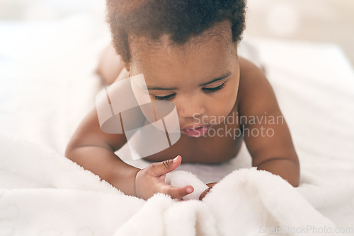 Image of Black girl, blanket and kids with a baby in a home, lying on the floor for growth or child development. Relax, children and family home with a newborn infant playing in the living room of a house