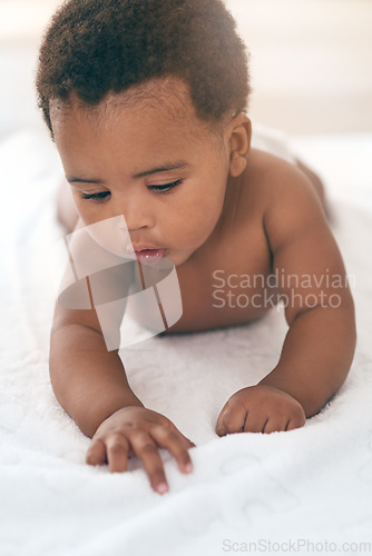 Image of Girl, lying and kids with a black baby in a home, towel on the floor for growth or child development. Relax, children and family home with a newborn infant playing in the living room of a house